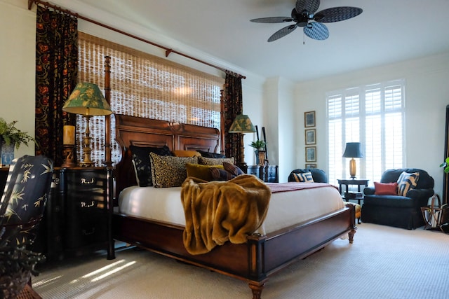 bedroom featuring ceiling fan, carpet floors, and ornamental molding