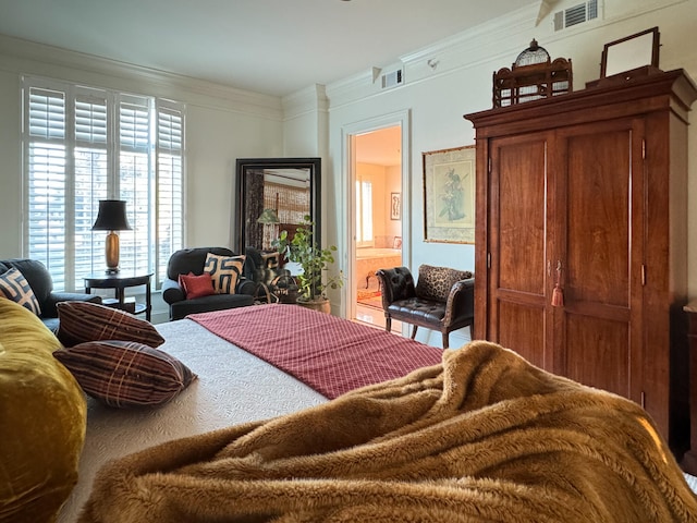 bedroom with ensuite bathroom and ornamental molding