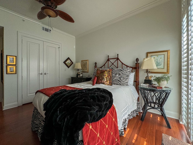 bedroom featuring ceiling fan, a closet, hardwood / wood-style floors, and ornamental molding