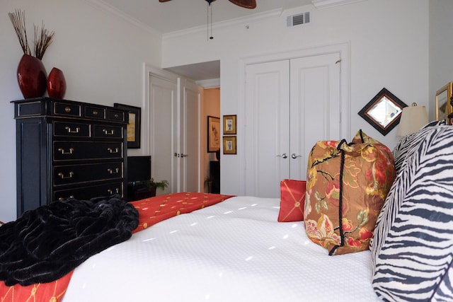 bedroom with ceiling fan, a closet, and ornamental molding