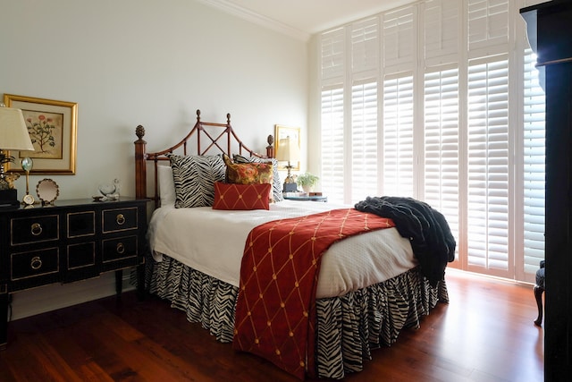 bedroom with multiple windows, crown molding, and dark hardwood / wood-style flooring