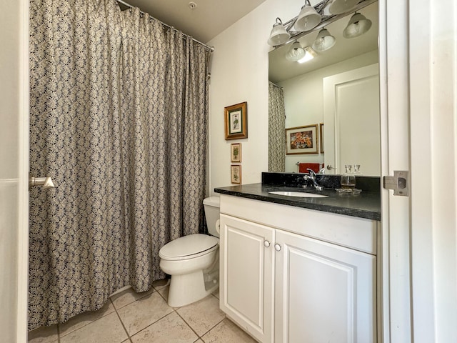 bathroom featuring tile patterned flooring, vanity, and toilet