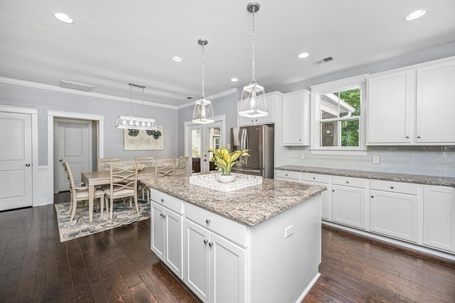 kitchen featuring stainless steel fridge with ice dispenser, dark wood-style floors, a kitchen island, white cabinetry, and pendant lighting