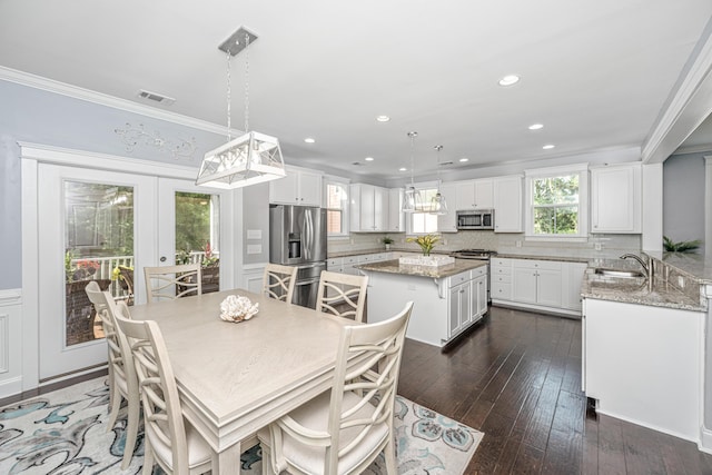 dining space featuring ornamental molding, dark wood-style flooring, recessed lighting, and french doors