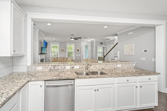 kitchen with dishwasher, a sink, crown molding, white cabinets, and recessed lighting
