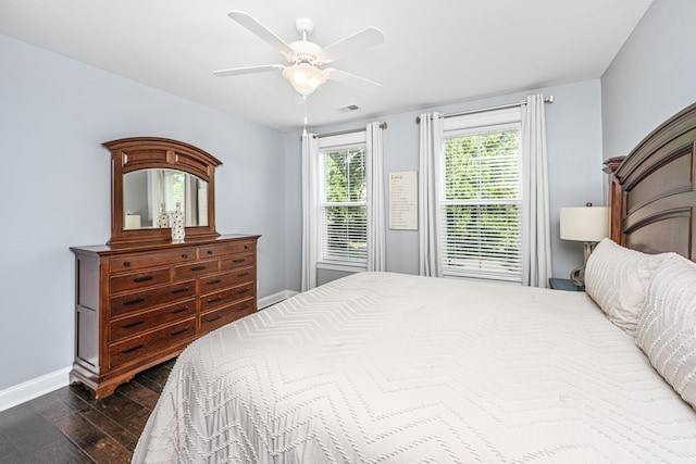 bedroom with dark wood-style flooring, baseboards, and ceiling fan