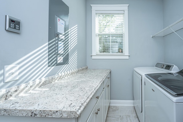 laundry room featuring washing machine and clothes dryer, baseboards, and arched walkways