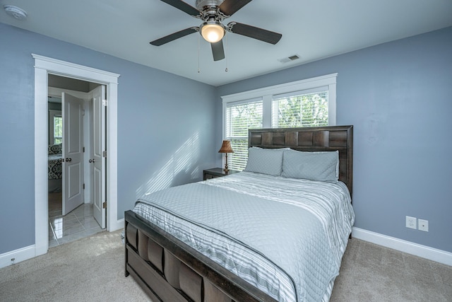 bedroom featuring light carpet, baseboards, and ceiling fan