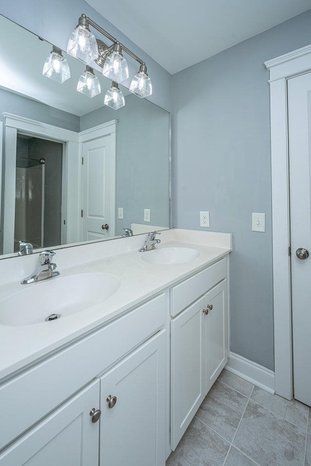 full bathroom featuring double vanity and baseboards