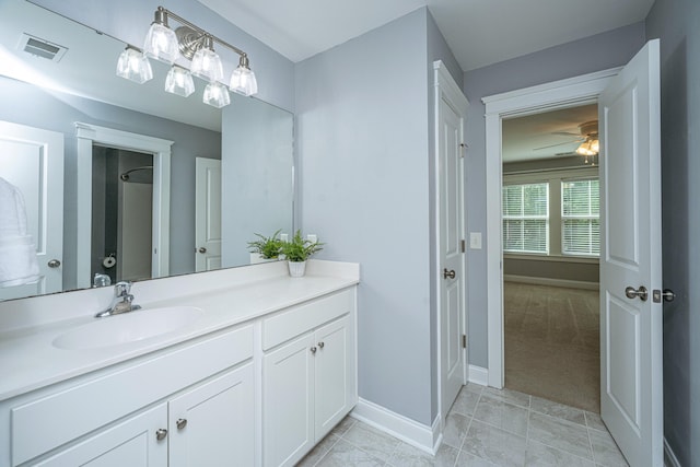 bathroom with baseboards, ceiling fan, vanity, and tile patterned floors