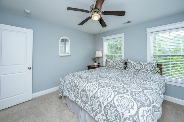 carpeted bedroom featuring baseboards and ceiling fan