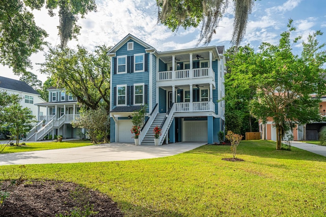 view of front of house with stairway, a ceiling fan, a porch, a front yard, and an attached garage