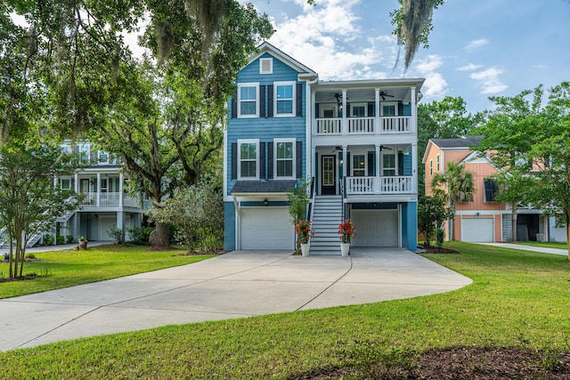 raised beach house with ceiling fan, stairway, a front yard, an attached garage, and concrete driveway