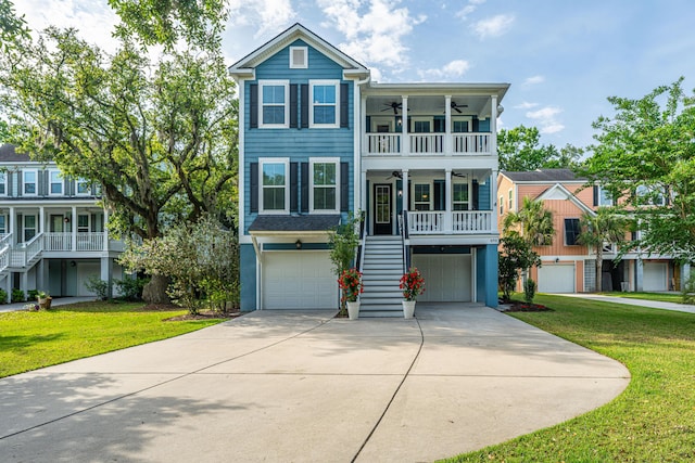raised beach house with stairs, ceiling fan, a front yard, and an attached garage