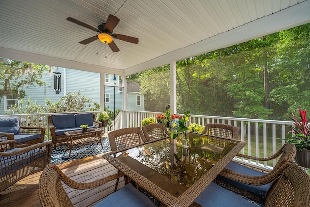 wooden terrace with an outdoor living space, ceiling fan, and outdoor dining space