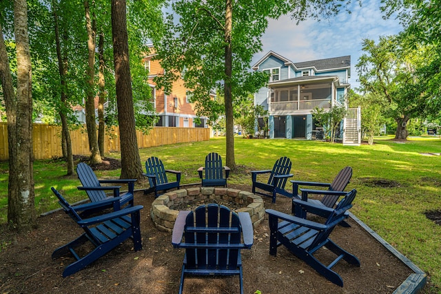 view of patio with a sunroom, a fire pit, and stairway