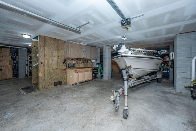 garage with a garage door opener and a workshop area