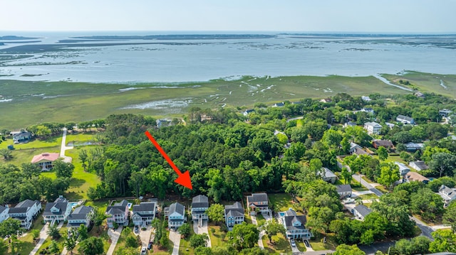 aerial view of property and surrounding area featuring nearby suburban area and a large body of water