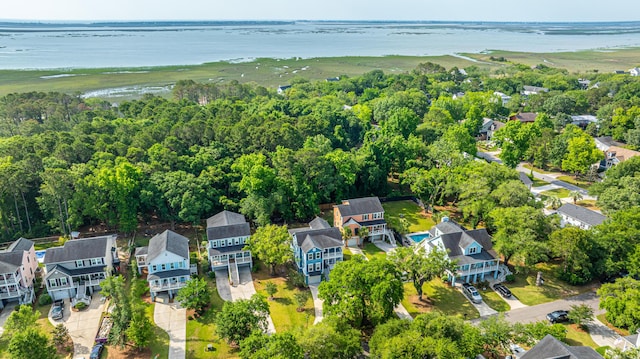 aerial view of residential area featuring a large body of water