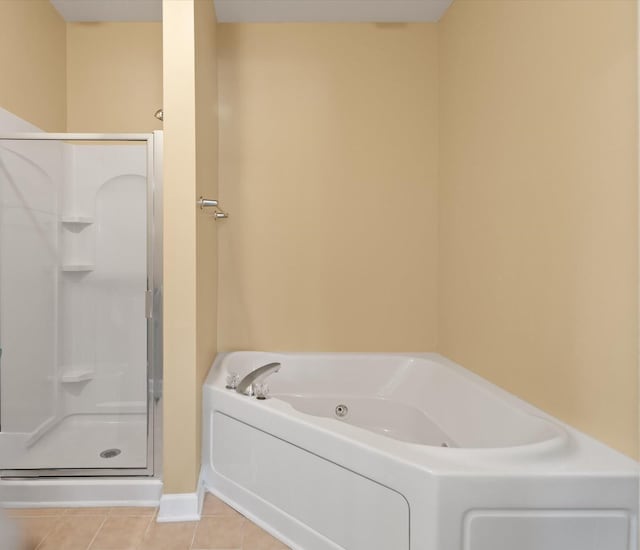 bathroom with separate shower and tub and tile patterned flooring