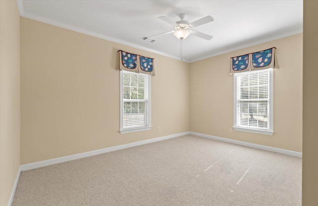 spare room with ornamental molding, light carpet, ceiling fan, and plenty of natural light