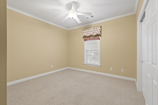 unfurnished bedroom featuring crown molding, a closet, light colored carpet, and ceiling fan