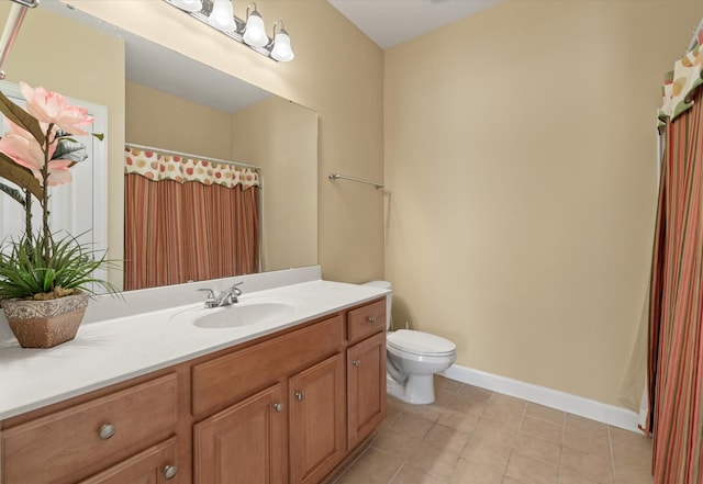 bathroom featuring vanity, toilet, and tile patterned floors