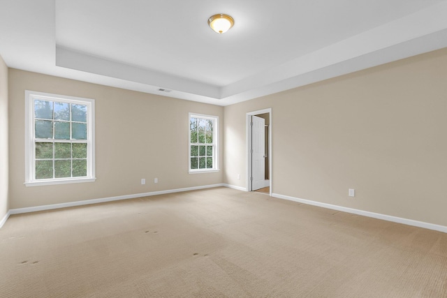 unfurnished room with visible vents, baseboards, and light colored carpet