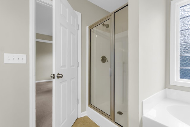 bathroom with a garden tub and a shower stall