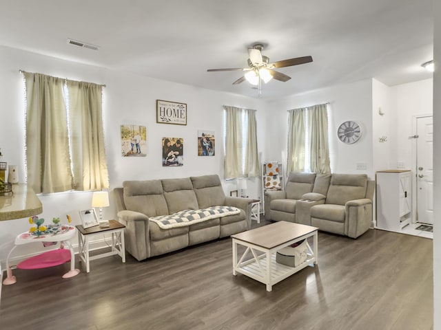 living room with ceiling fan and dark hardwood / wood-style flooring