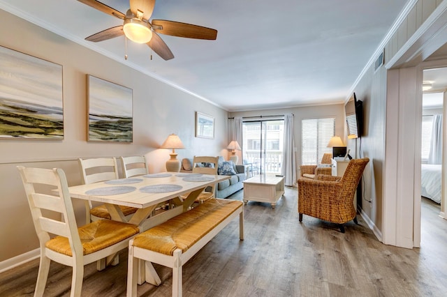 1400 Ocean Blvd Unit 106B, Isle Of Palms, SC 29451 - dining space with crown molding, wood finished floors, and a ceiling fan