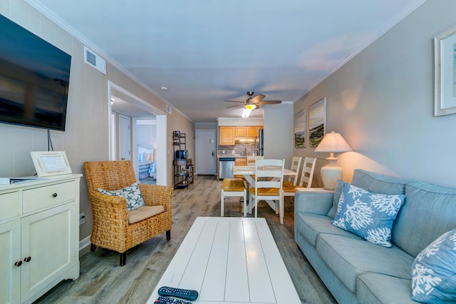 1400 Ocean Blvd Unit 106B, Isle Of Palms, SC 29451 - living area featuring light wood-style flooring, ceiling fan, and crown molding