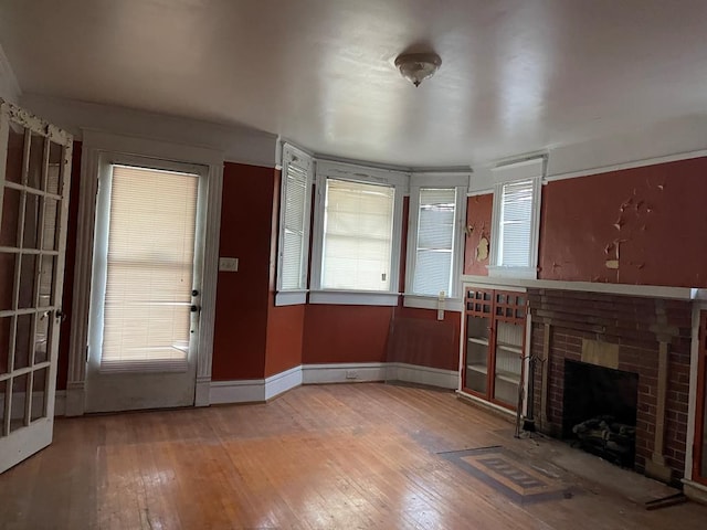 unfurnished living room featuring a fireplace and hardwood / wood-style floors