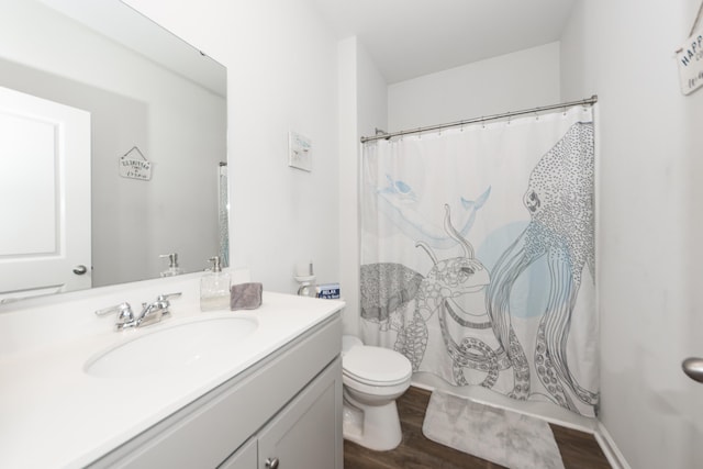 bathroom featuring toilet, oversized vanity, and hardwood / wood-style floors