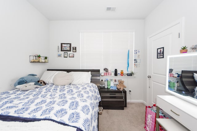 bedroom featuring light carpet