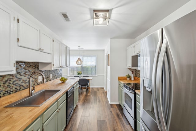 1027 Wayfarer Ln, Charleston, SC 29412 - kitchen featuring appliances with stainless steel finishes, wooden counters, a sink, tasteful backsplash, and white cabinets