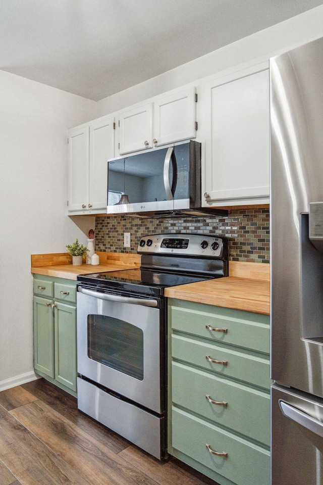 1027 Wayfarer Ln, Charleston, SC 29412 - kitchen with appliances with stainless steel finishes, green cabinets, decorative backsplash, and wooden counters