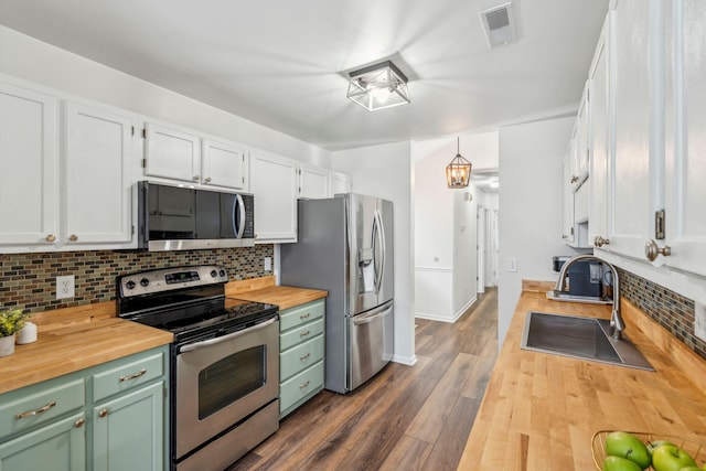 1027 Wayfarer Ln, Charleston, SC 29412 - kitchen featuring wood counters, appliances with stainless steel finishes, a sink, and decorative backsplash
