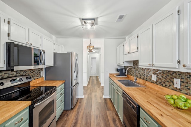 1027 Wayfarer Ln, Charleston, SC 29412 - kitchen featuring butcher block countertops, appliances with stainless steel finishes, a sink, dark wood-type flooring, and white cabinetry