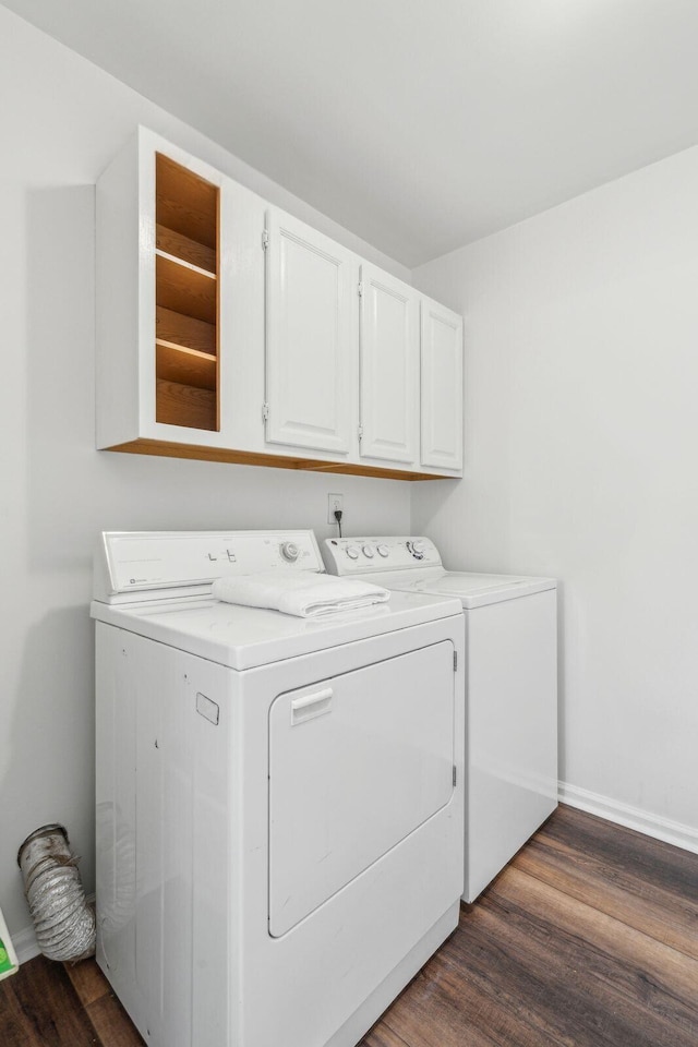 1027 Wayfarer Ln, Charleston, SC 29412 - washroom featuring washing machine and dryer, cabinet space, dark wood-style flooring, and baseboards