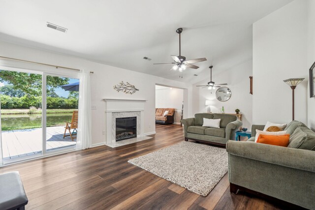 1027 Wayfarer Ln, Charleston, SC 29412 - living room with dark wood-style flooring, a ceiling fan, a premium fireplace, lofted ceiling, and a water view