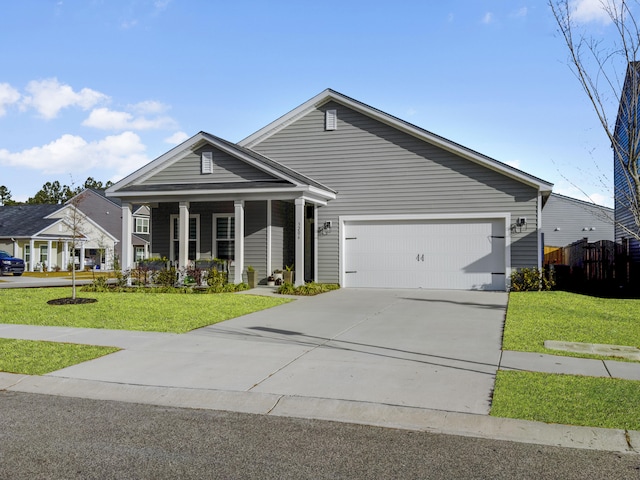 view of front of house with a porch, a garage, and a front yard