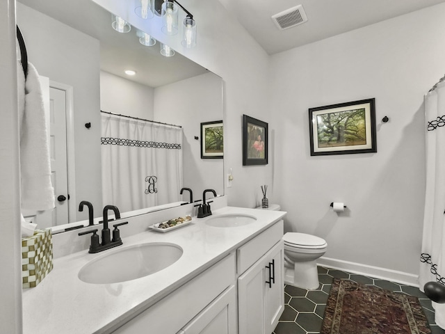 bathroom featuring tile patterned floors, toilet, and vanity