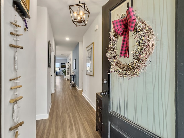 interior space featuring hardwood / wood-style flooring and a notable chandelier