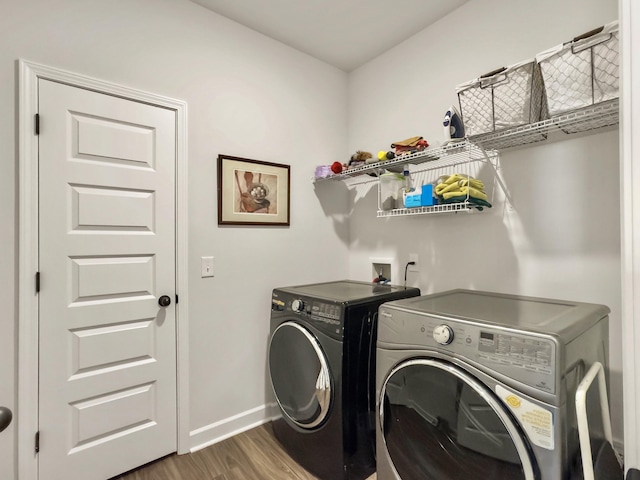 laundry area featuring separate washer and dryer and dark hardwood / wood-style flooring