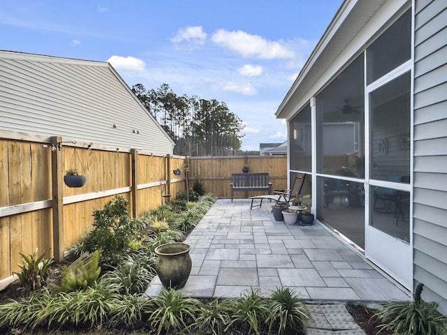 view of patio featuring a sunroom