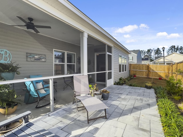 view of patio / terrace with ceiling fan and a sunroom