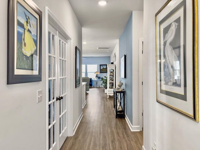 hallway featuring dark hardwood / wood-style floors and french doors