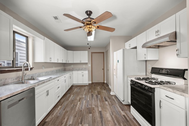 kitchen featuring white cabinets, light countertops, dishwasher, and gas range