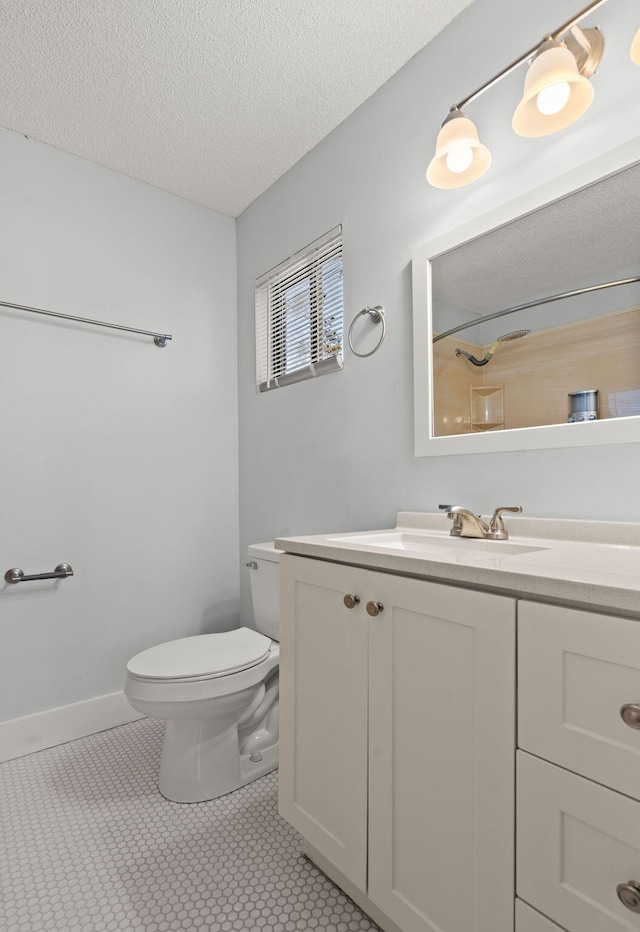 full bathroom with baseboards, toilet, tile patterned floors, a textured ceiling, and vanity